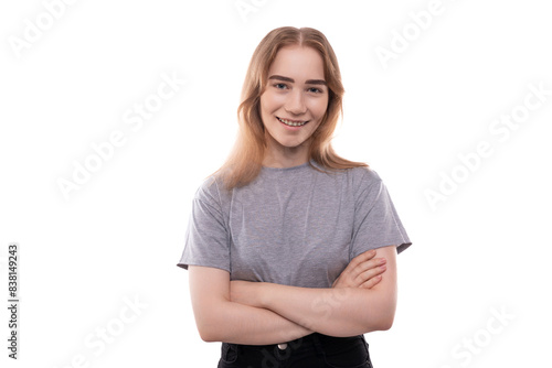 Kind modest bright blond teenager girl with braces in a gray T-shirt