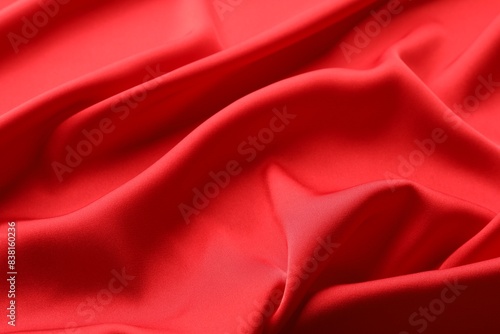Crumpled red silk fabric as background, closeup