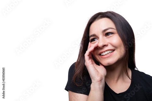 Young modest woman with brown eyes wearing a black T-shirt on a background with copy space