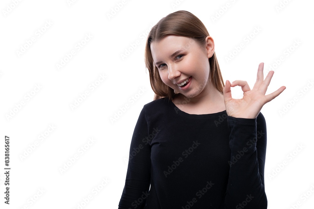 European joyful schoolgirl wearing a black turtleneck on a white studio background European joyful schoolgirl wearing a black turtleneck on a white studio background