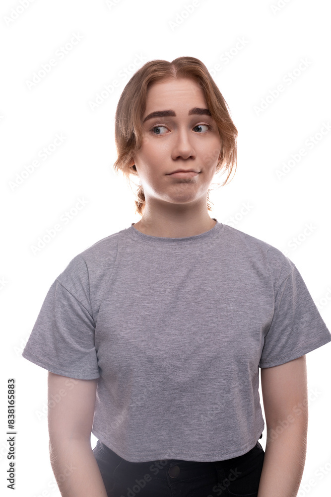 Teenage girl is afraid and looks suspiciously to the side Teenage girl is afraid and looks suspiciously to the side