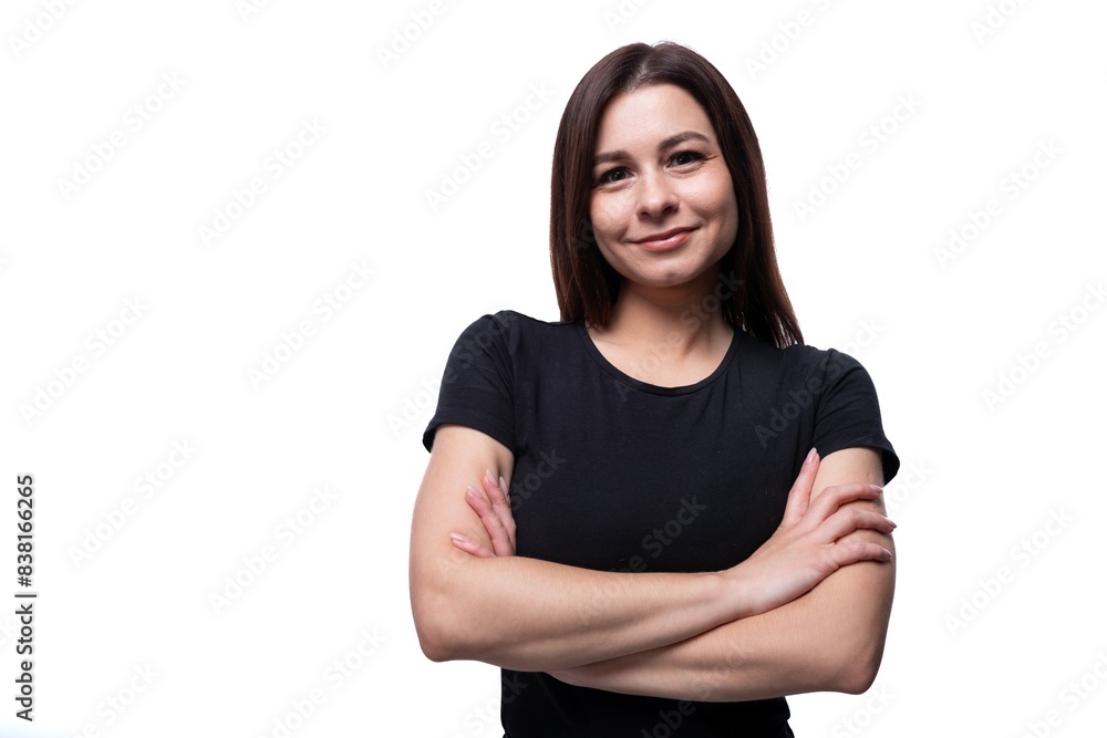 Young confident woman with brown eyes wearing a black T-shirt on a white background Young confident woman with brown eyes wearing a black T-shirt on a white background