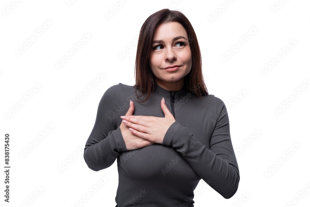 Casual young brunette woman wearing a marsh-colored turtleneck on a white background, close-up Casual young brunette woman wearing a marsh-colored turtleneck on a white background, close-up
