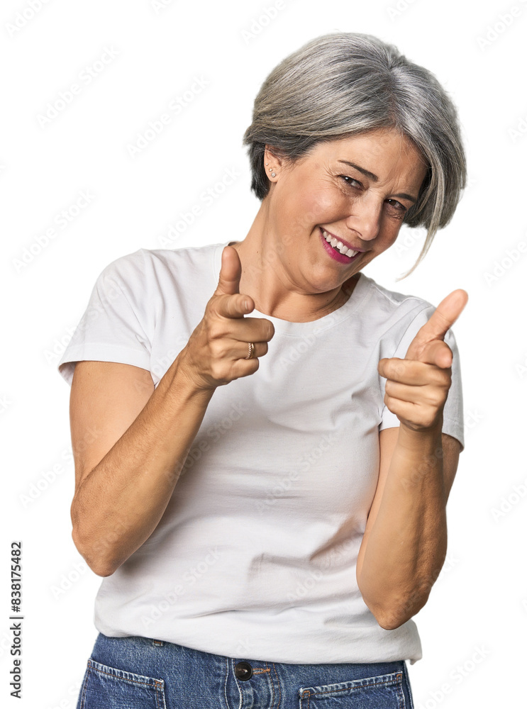 Caucasian mid-age female on studio background pointing to front with fingers. Caucasian mid-age female on studio background pointing to front with fingers.