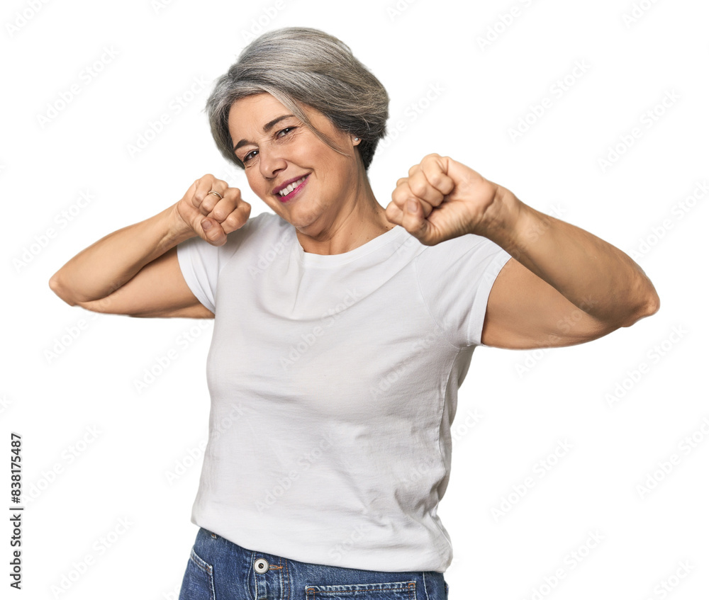 Caucasian mid-age female on studio background celebrating a special day, jumps and raise arms with energy. Caucasian mid-age female on studio background celebrating a special day, jumps and raise arms with energy.