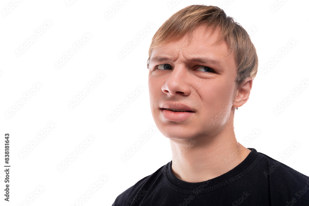Portrait of a surprised teenage guy with blond hair on a white background Portrait of a surprised teenage guy with blond hair on a white background