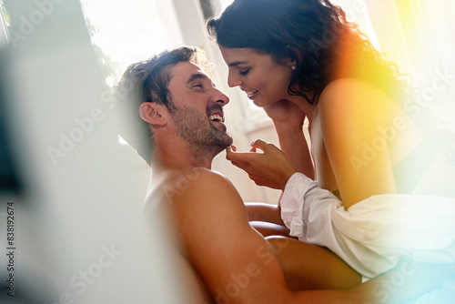 Loving couple having erotic moments in bedroom