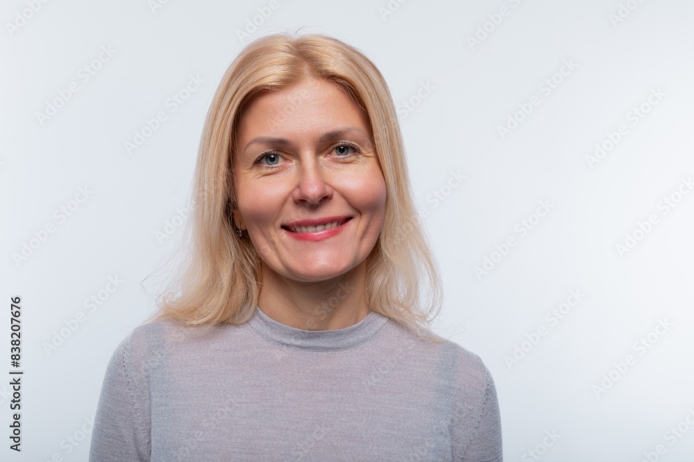 Charming 45 year old woman with blond hair wears light makeup Charming 45 year old woman with blond hair wears light makeup