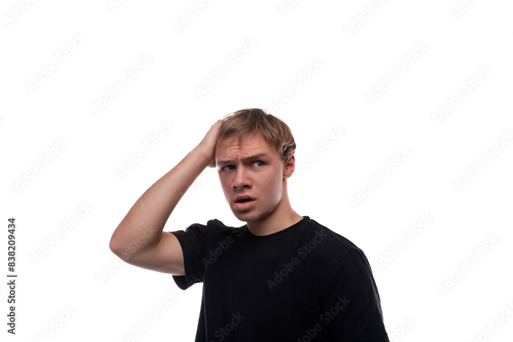 Blonde teenager dressed in a basic t-shirt is upset and thinking Blonde teenager dressed in a basic t-shirt is upset and thinking