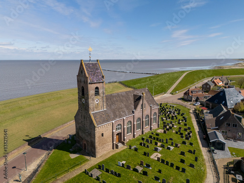 Aerial View: Picturesque Church by the Dike in Wierum Village, Friesland, Netherlands photo