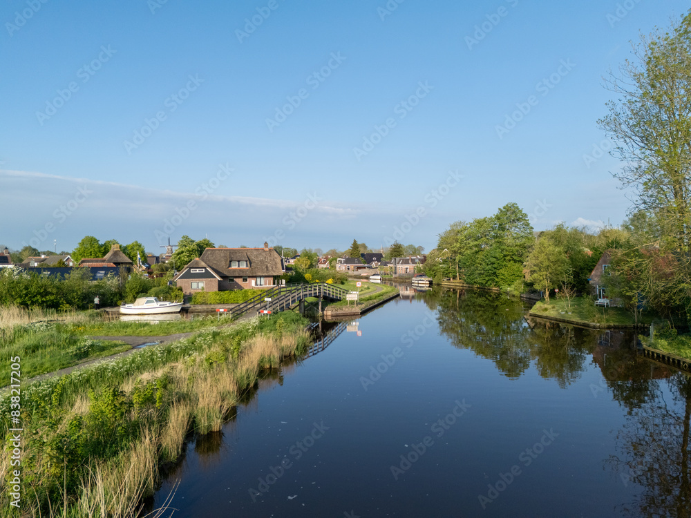 Aerial View: Village Burdaard in Friesland, Netherlands with houses Aerial View: Village Burdaard in Friesland, Netherlands with houses