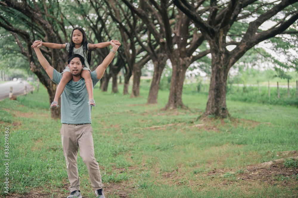 Obraz premium Happy father and daughter hugging while standing at countryside,Father'day concept,enjoying tender moment