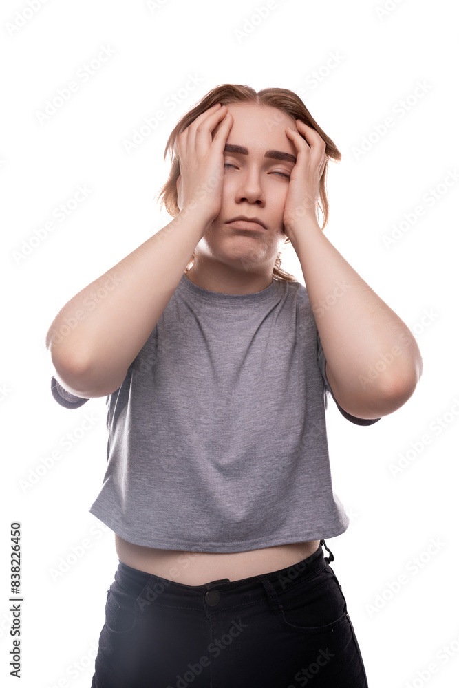 Tired Caucasian fair-haired teenage girl in a gray T-shirt close-up Tired Caucasian fair-haired teenage girl in a gray T-shirt close-up