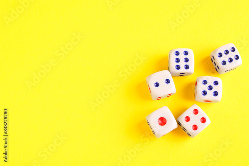 Many white game dices on yellow background  flat lay. Space for text
