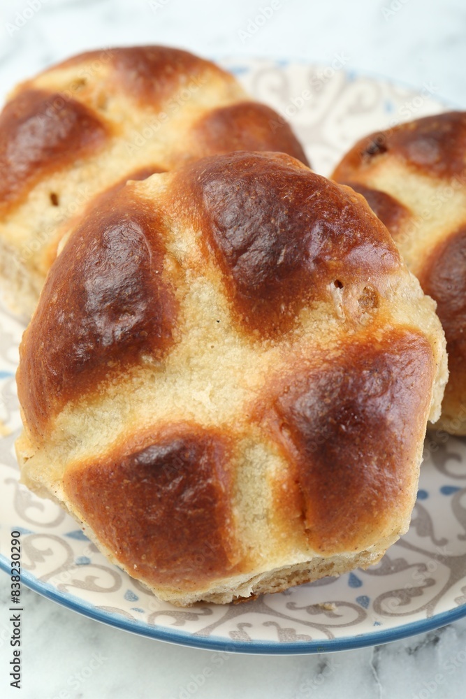 Hot cross buns on white table, closeup Hot cross buns on white table, closeup