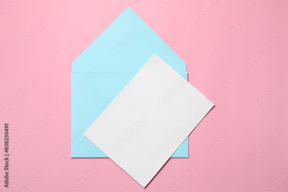 Letter envelope and card on pink background, top view Letter envelope and card on pink background, top view
