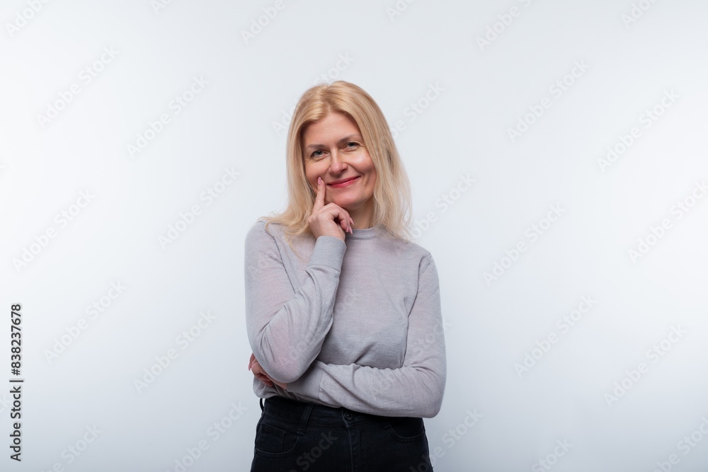 Charming 45 year old woman with blond hair wears light makeup Charming 45 year old woman with blond hair wears light makeup