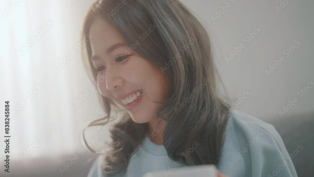 Women are playing with their mobile phones on the sofa and on the dining table and drinking coffee at the same time. Women are playing with their mobile phones on the sofa and on the dining table and drinking coffee at the same time.