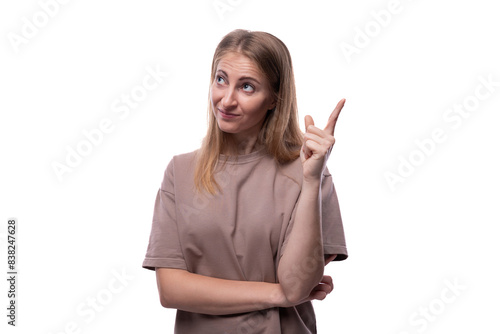 Portrait of a pensive Caucasian blonde woman in a T-shirt with bright facial expressions