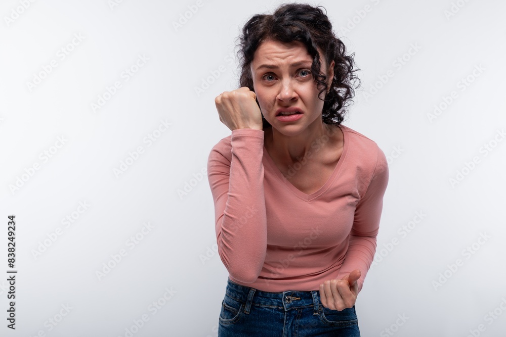 Brunette curly woman doubts and worries. Negative emotions concept Brunette curly woman doubts and worries. Negative emotions concept