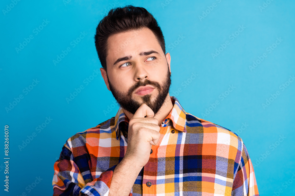 Portrait of nice young man look empty space wear shirt isolated on blue color background