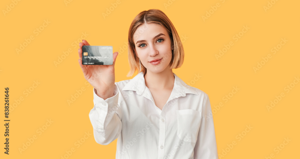 Online bank. Cashback offer. Best proposition. Financial success. Happy woman classy look presenting debit card isolated on yellow empty space. Online bank. Cashback offer. Best proposition. Financial success. Happy woman classy look presenting debit card isolated on yellow empty space.