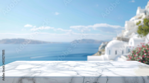 Empty white marble table top with blurred background of blue sea, white houses and mountains, sunny summer day, blue sky. Background for demonstration, installation, montage of products