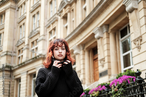 Intense portrait of young woman in front of old building. © Jorge Elizaquibel