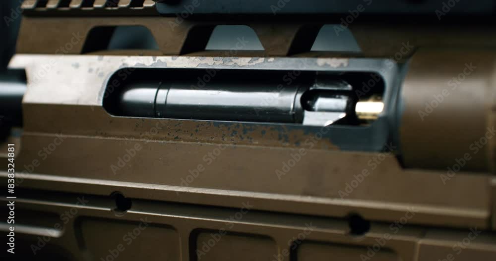 Super slow motion close up of empty bullet shell casing is flying out of machine fire gun during training in a shooting range. Shooting and Weapons Super slow motion close up of empty bullet shell casing is flying out of machine fire gun during training in a shooting range. Shooting and Weapons