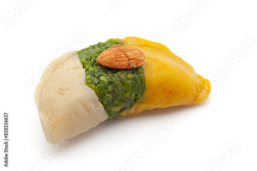 Close-up of Delicious Tricolour Indian sweet Khoya Barfi in the shape of gujiya. Made up of Mawa, Milk, and Sugar isolated on white background. photo