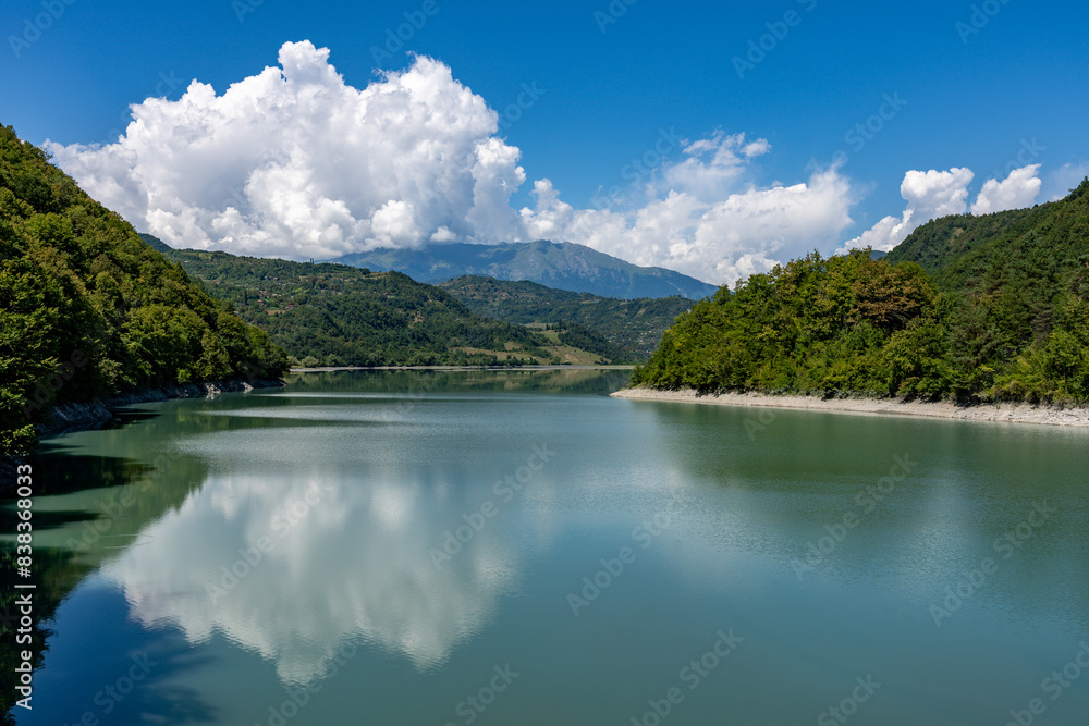Clear lake in mountains with nice reflection of sky and clouds Clear lake in mountains with nice reflection of sky and clouds