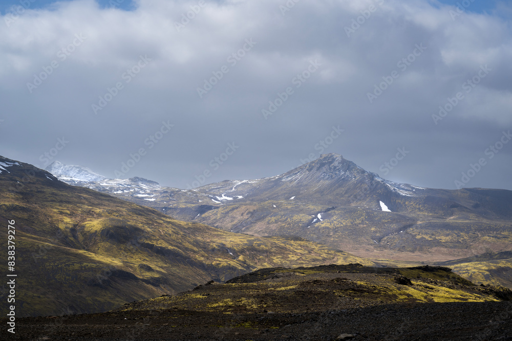 Land- and mountainscape on snaefellsnes on iceland in summer under dramatic clouds