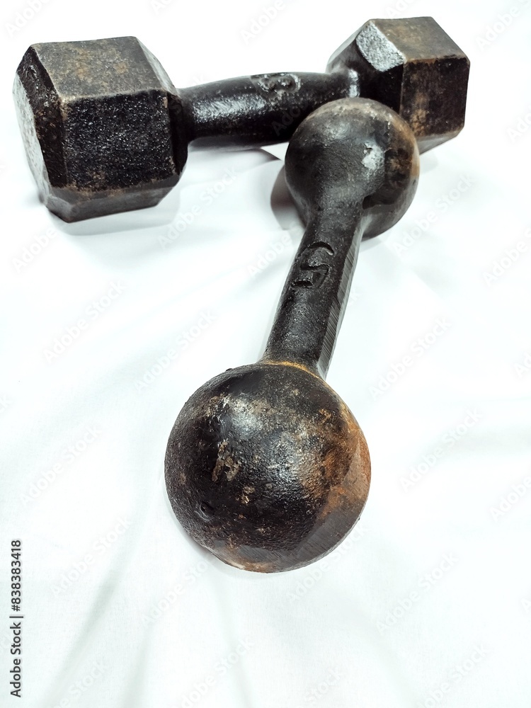 Two isolated black cast dumbbells on a white background
Two isolated black cast dumbbells on a white background