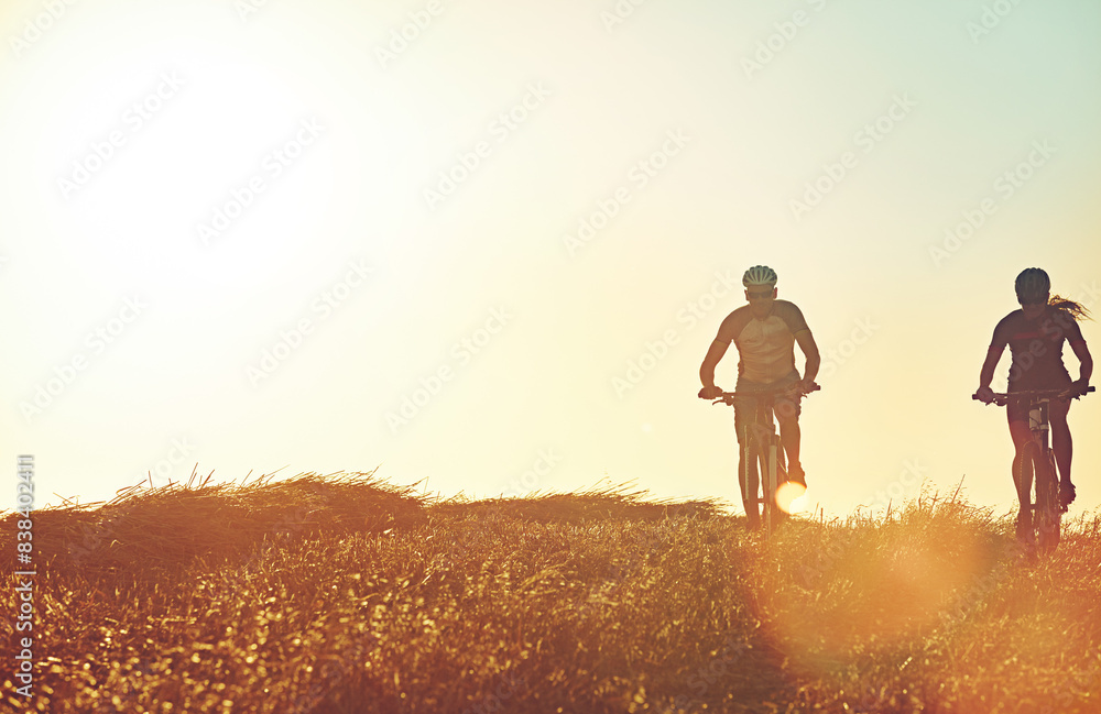 Fototapeta premium Sunset sky, people and team in bicycle race with grass, exercise and adventure trail in nature together. Cycling, fitness and friends with mountain bike in evening for outdoor workout, sun and mockup