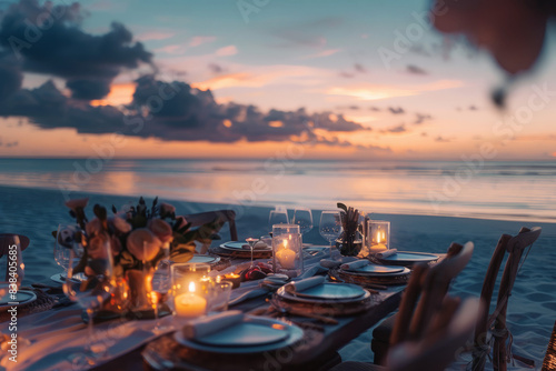 Table with cutlery, candles as a romantic dinner on the beach of the sea or ocean 