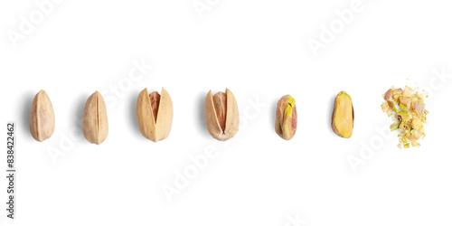 Sequence of pistachio nut opening from closed shell to crushed nut on white background
