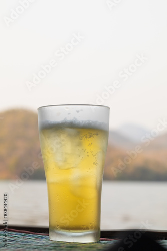 Beer, served in glasses, is a popular alcoholic drink around the world and is often used as a celebratory drink during festivals. Beer was served with ice in beer glasses because of the hot weather.