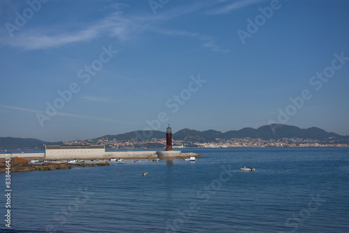 The lighthouse of the Sea Museum seen from the Bouzas breakwater in Vigo, Pontevedra, Spain photo