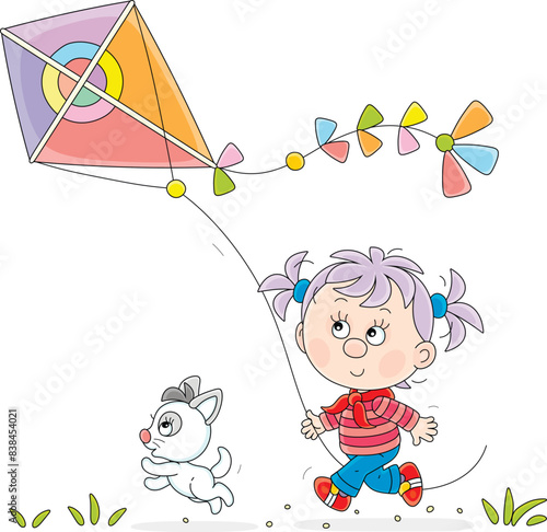 Happy little girl and a merry kitten running and playing with a flying colorful toy kite on a playground in a park on a summer vacation, vector cartoon illustration isolated on white