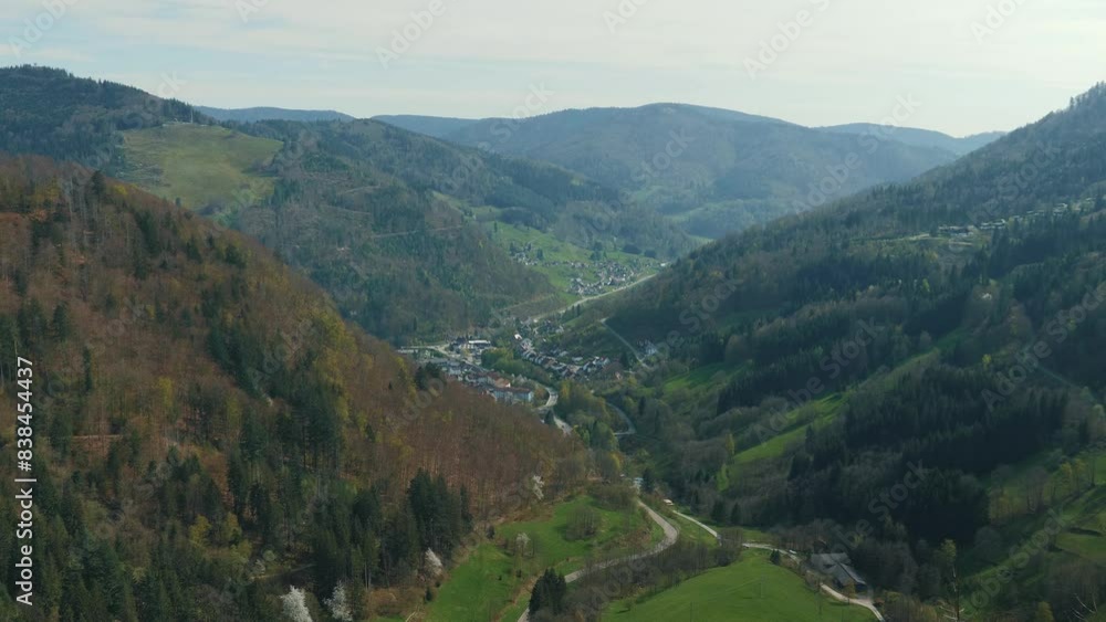 Mountain valley with green hills and village on horizon in Schwarzwald, Germany Mountain valley with green hills and village on horizon in Schwarzwald, Germany