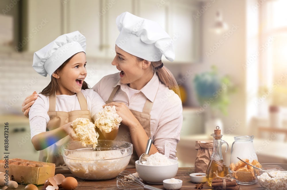 Joyful Mother And Daughter Cooking At Modern Kitchen Joyful Mother And Daughter Cooking At Modern Kitchen