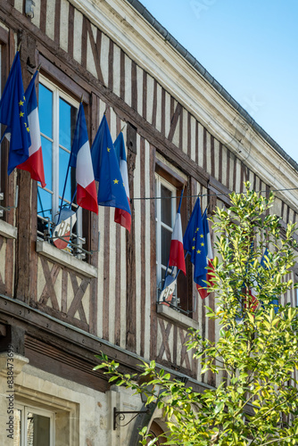 Driving in Champagne wine making region in Champagne, France. Streets, house decorated with french flags, summertime photo