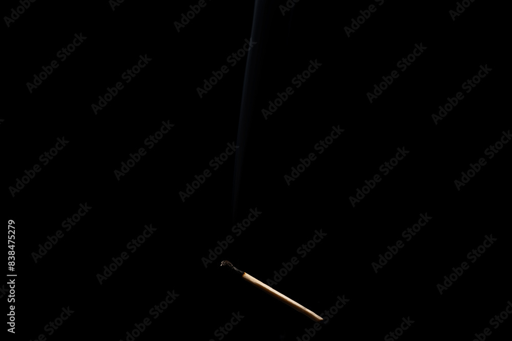 Lit falling match on a black background. Lit falling match on a black background.