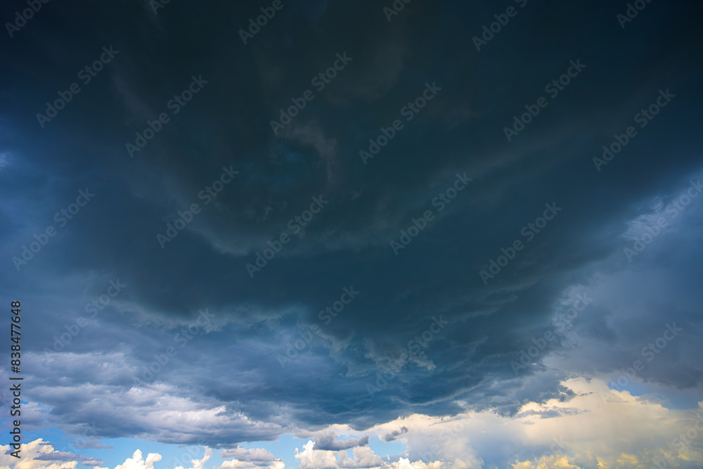 Obraz premium Dramatic storm clouds in blue sky associated with storm, dark, moody weather and looming atmosphere