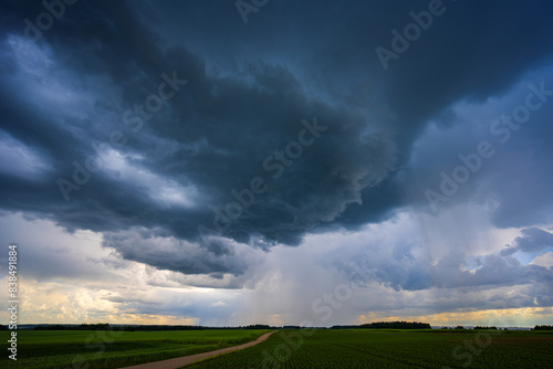 Dramatic storm clouds in blue sky associated with storm, dark, moody weather and looming atmosphere