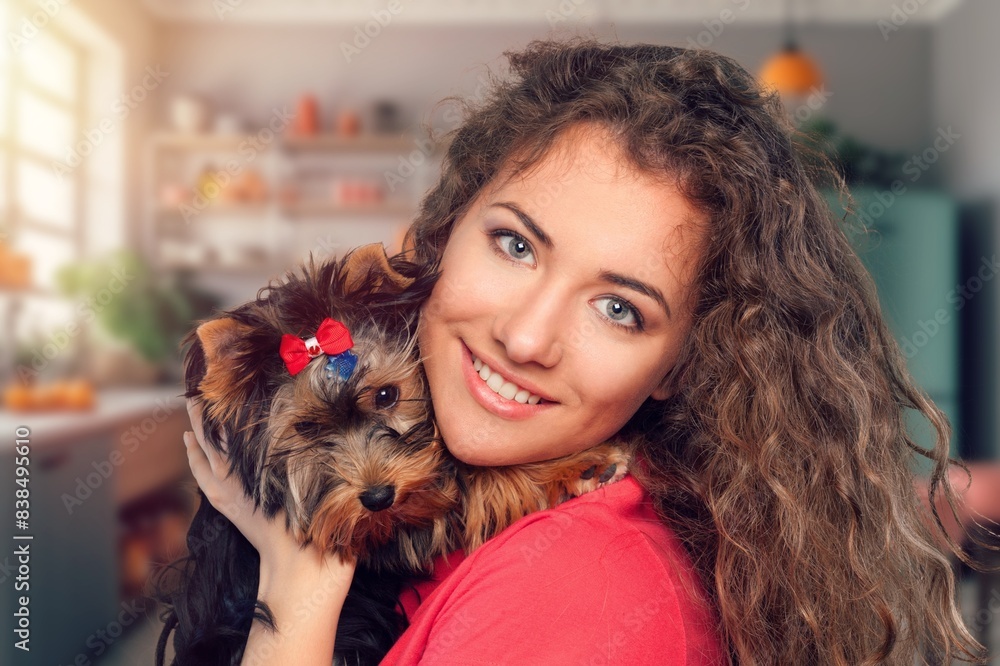 young girl hold hug cute dog at home
