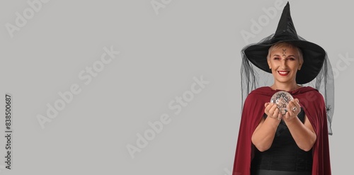 Mature witch holding crysta...