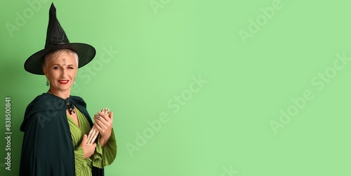 Mature witch holding spell ...