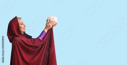 Mature witch holding human ...