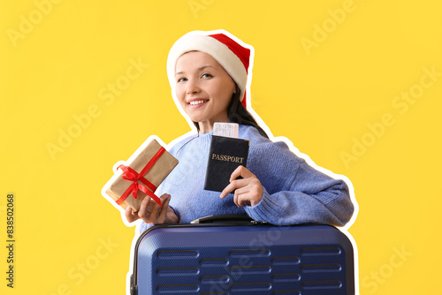 Young woman in Santa hat wi...